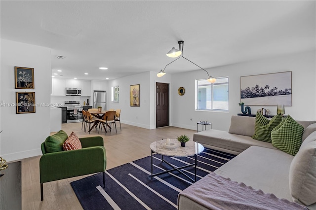 living room with light hardwood / wood-style flooring