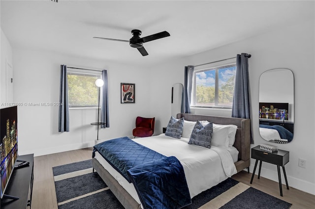 bedroom with ceiling fan and hardwood / wood-style flooring