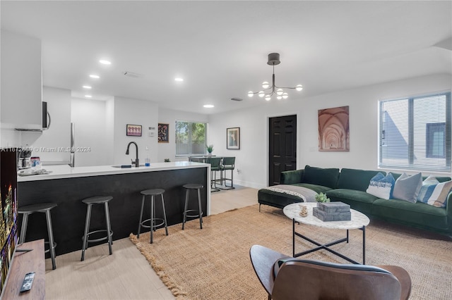 living room featuring sink and a chandelier