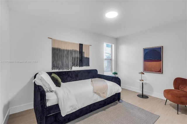 bedroom with wood-type flooring