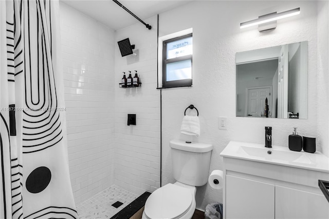 bathroom with curtained shower, vanity, and toilet