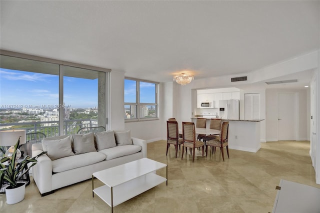 living room featuring expansive windows and a notable chandelier