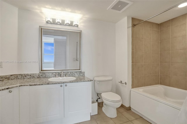 full bathroom with vanity, tile patterned flooring, tiled shower / bath, and toilet