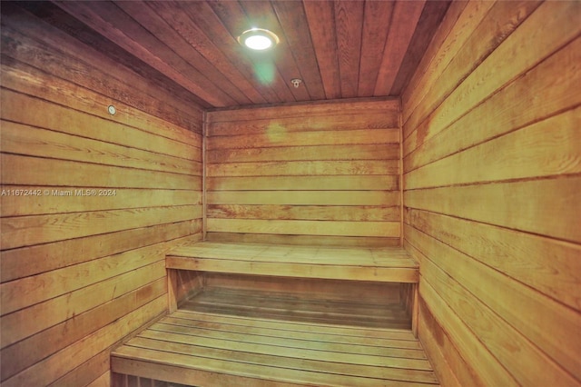 view of sauna / steam room with wooden walls and wooden ceiling