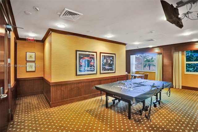 game room featuring light colored carpet and wooden walls