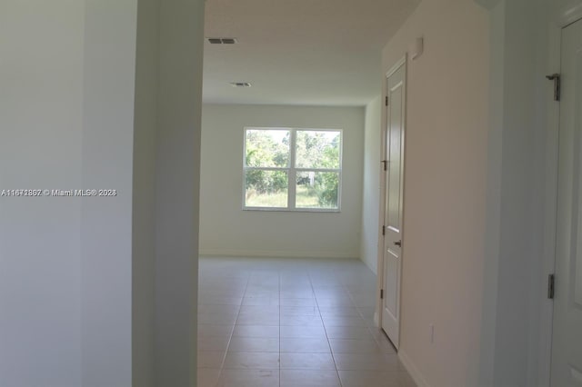 hallway featuring light tile patterned floors