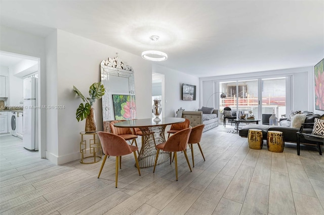 dining room featuring light hardwood / wood-style flooring and washer / clothes dryer