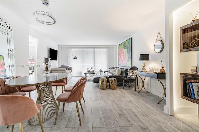 dining room featuring light hardwood / wood-style flooring and a wealth of natural light