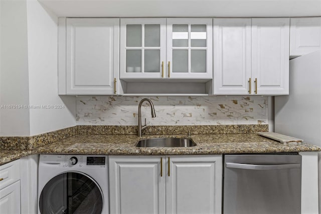 clothes washing area featuring washer / clothes dryer and sink