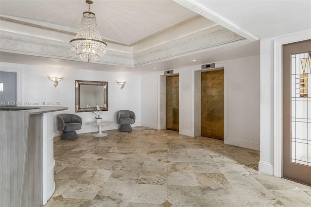 bathroom with an inviting chandelier and a raised ceiling