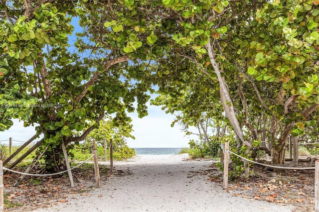 surrounding community featuring a view of the beach and a water view