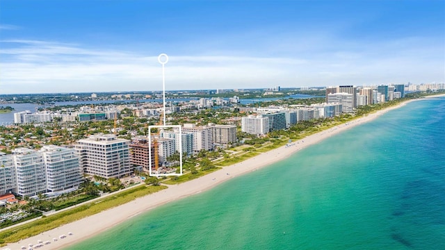 aerial view with a water view and a view of the beach