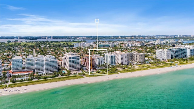 aerial view with a water view and a beach view