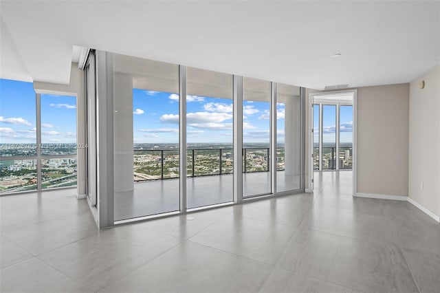 empty room featuring expansive windows and plenty of natural light