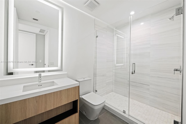 bathroom featuring tile patterned flooring, a shower with door, vanity, and toilet