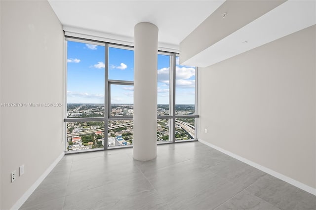 unfurnished room with floor to ceiling windows