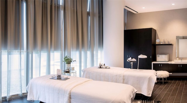 bedroom featuring dark hardwood / wood-style floors and sink