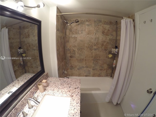 bathroom featuring vanity and shower / bathtub combination with curtain