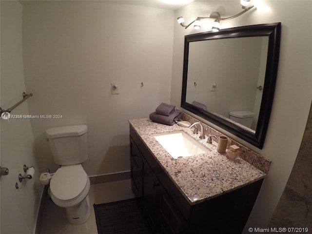 bathroom featuring vanity, toilet, and tile patterned floors