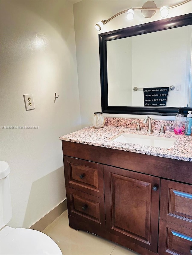 bathroom featuring vanity, toilet, and tile patterned floors