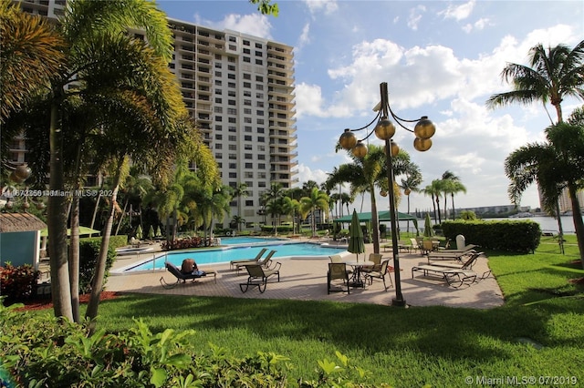 view of swimming pool with a yard and a patio area