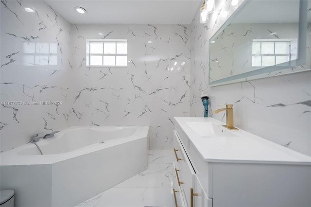 bathroom featuring vanity, a bath, toilet, and a healthy amount of sunlight