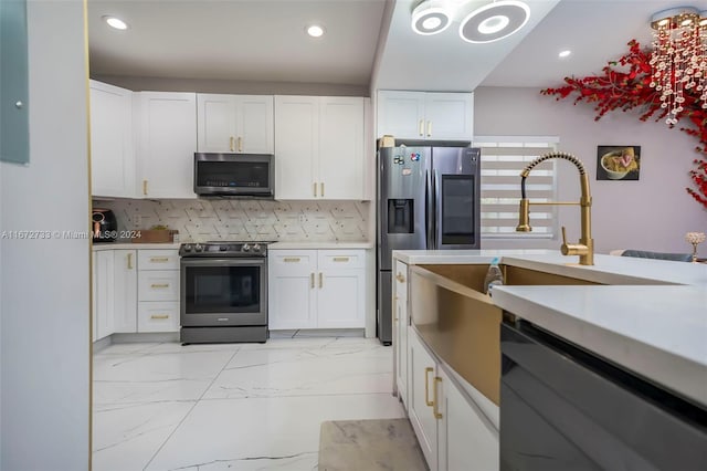 kitchen featuring backsplash, stainless steel appliances, and white cabinets