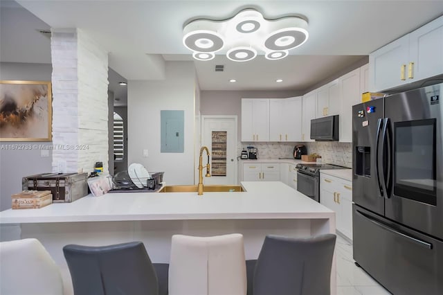 kitchen with electric panel, a breakfast bar, white cabinets, and appliances with stainless steel finishes