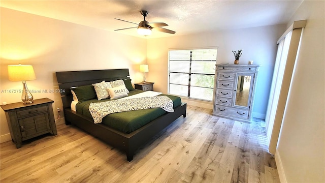 bedroom with light wood-type flooring and ceiling fan