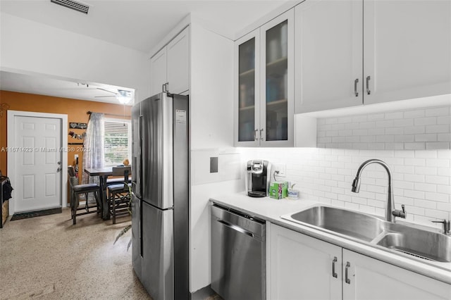 kitchen with visible vents, a sink, stainless steel appliances, white cabinets, and light countertops