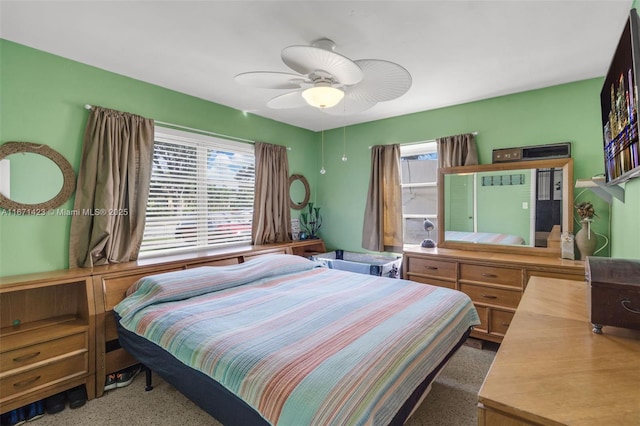 bedroom featuring multiple windows, speckled floor, and a ceiling fan