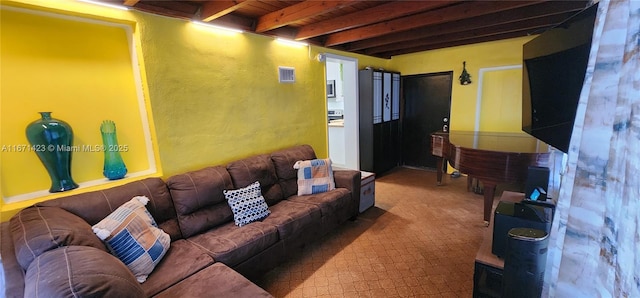 living area featuring wooden ceiling, beamed ceiling, a textured wall, and visible vents