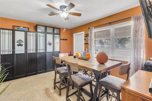 dining space with a ceiling fan