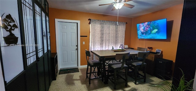 dining area featuring speckled floor and a ceiling fan