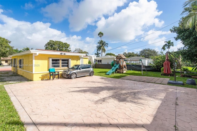 view of front of house featuring a front lawn and a playground