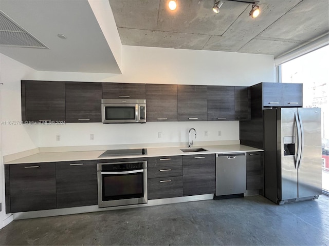 kitchen featuring dark brown cabinetry, stainless steel appliances, and sink