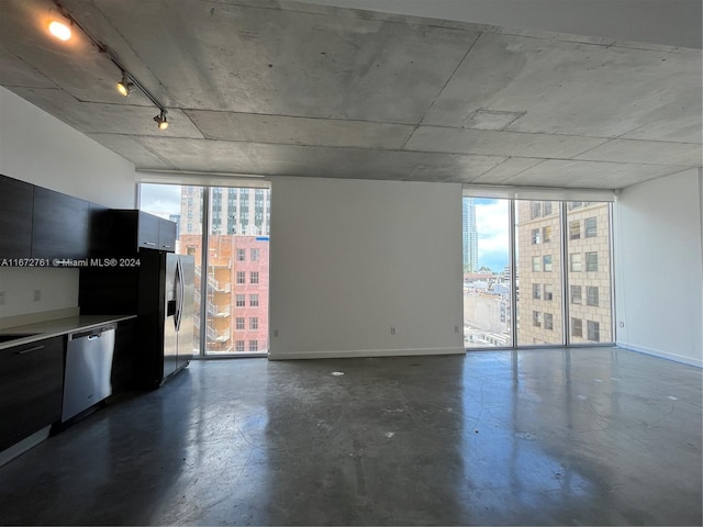 unfurnished living room with expansive windows and plenty of natural light