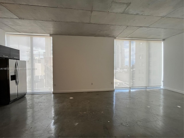 unfurnished room with concrete floors