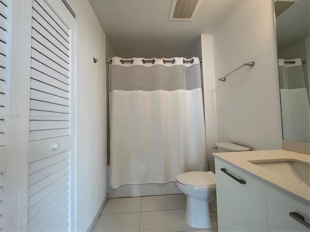 bathroom featuring vanity, toilet, tile patterned floors, and curtained shower