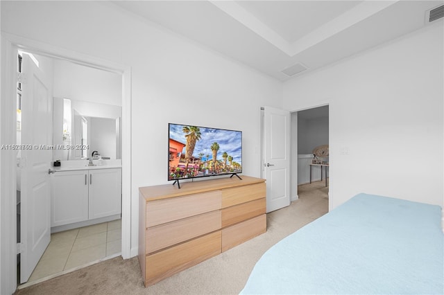 bedroom featuring light carpet and sink