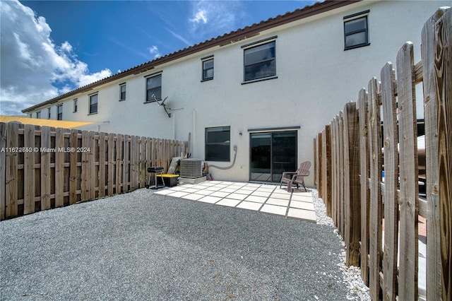 back of house with a patio and central AC