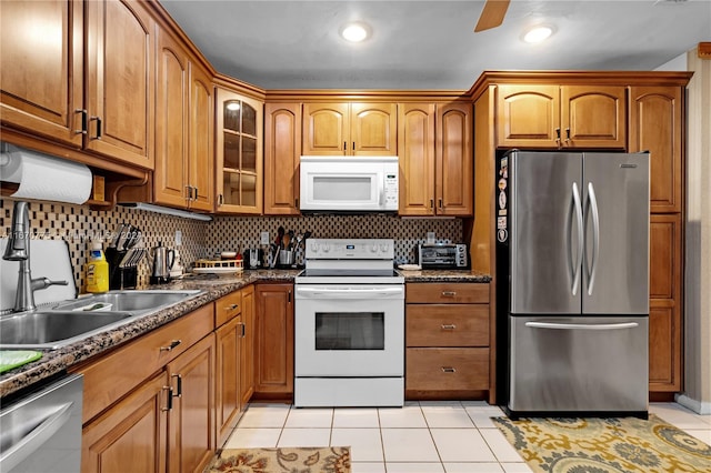 kitchen with light tile patterned floors, stainless steel appliances, and tasteful backsplash