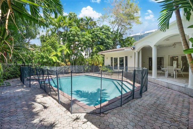 view of swimming pool featuring ceiling fan and a patio