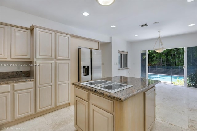 kitchen with pendant lighting, a kitchen island, electric stovetop, dark stone counters, and stainless steel fridge with ice dispenser