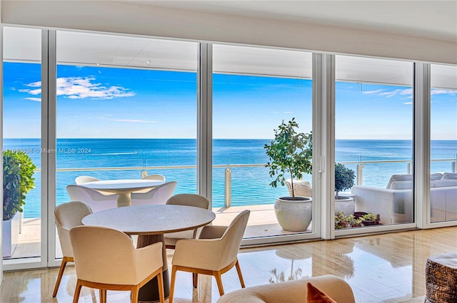 sunroom / solarium featuring a water view and a wealth of natural light