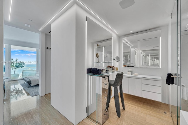 bathroom featuring hardwood / wood-style flooring and vanity