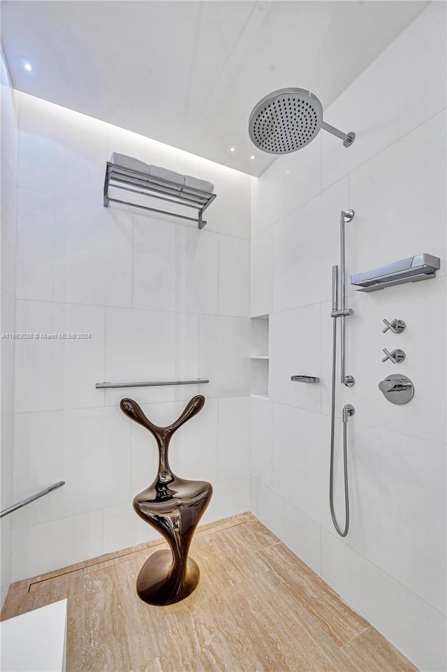 bathroom with a tile shower