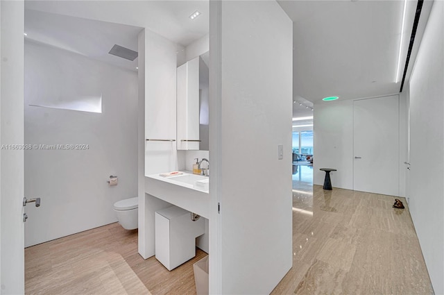 bathroom featuring vanity, toilet, and hardwood / wood-style flooring