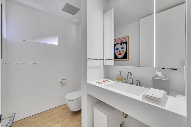 bathroom with vanity, hardwood / wood-style floors, and toilet