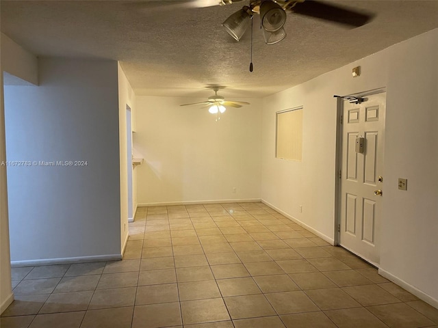 tiled spare room featuring ceiling fan and a textured ceiling